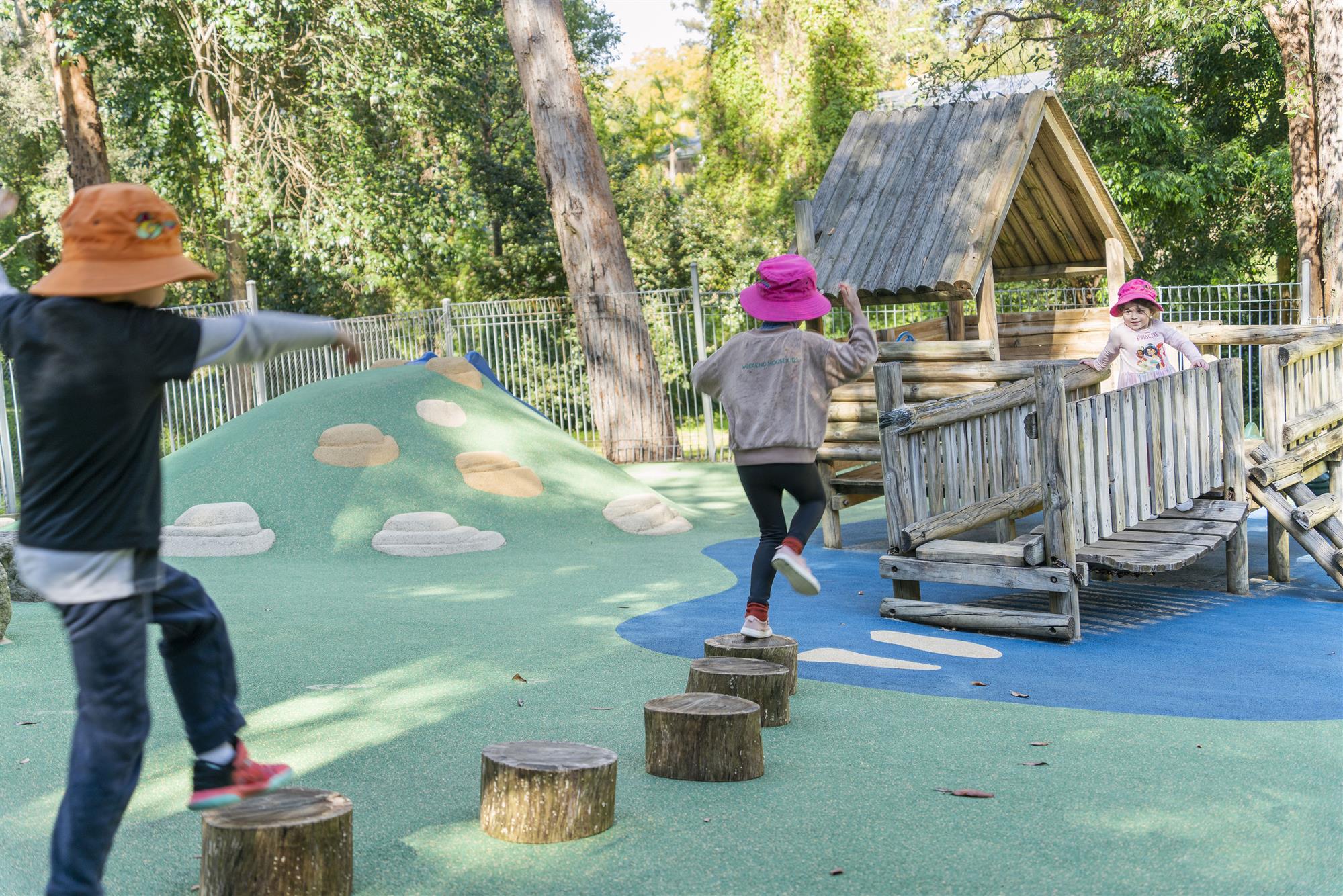 Children crossing over logs