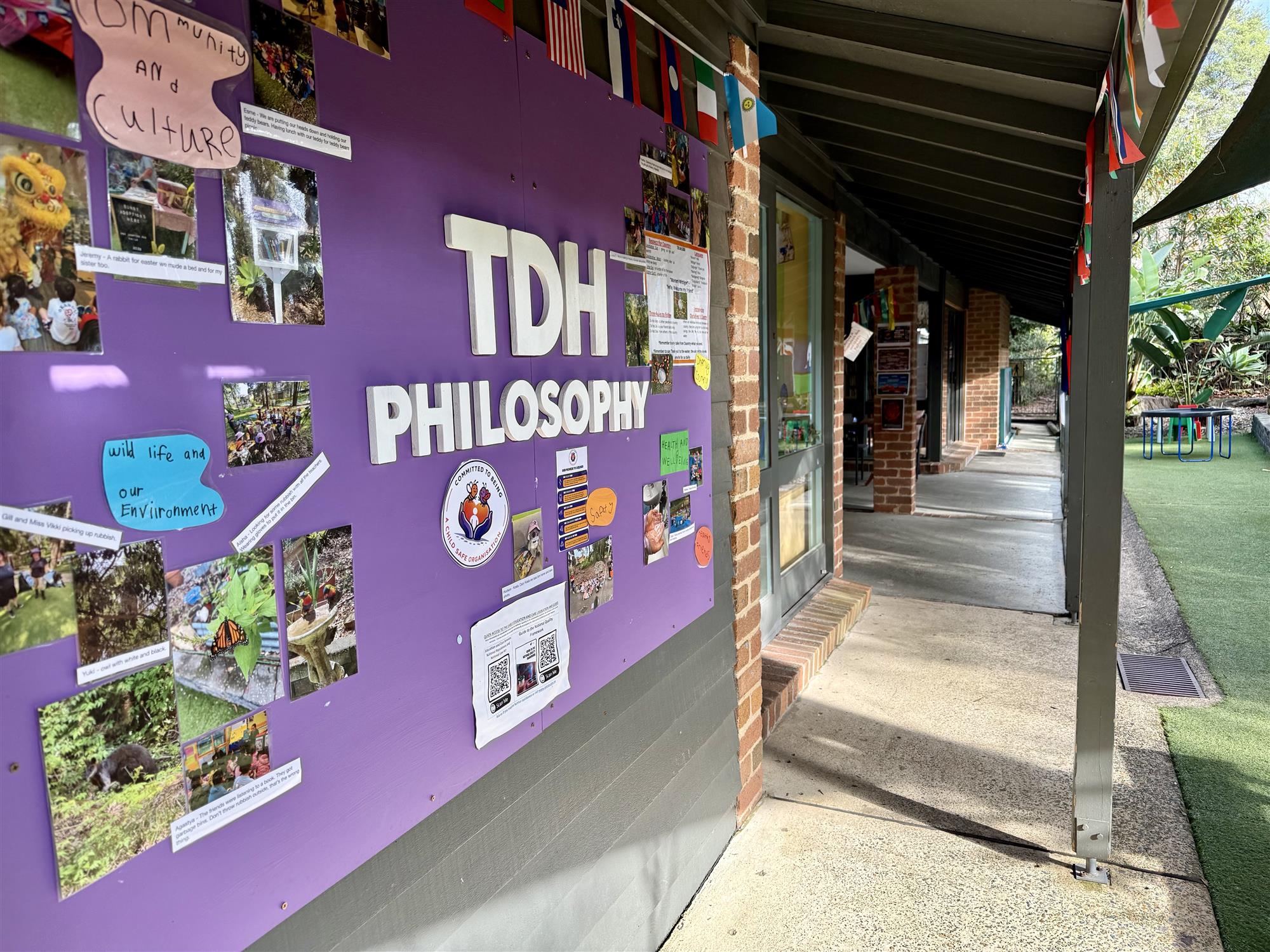 The Discovery House philosophy wall, displaying children's artwork and the values that shape our program