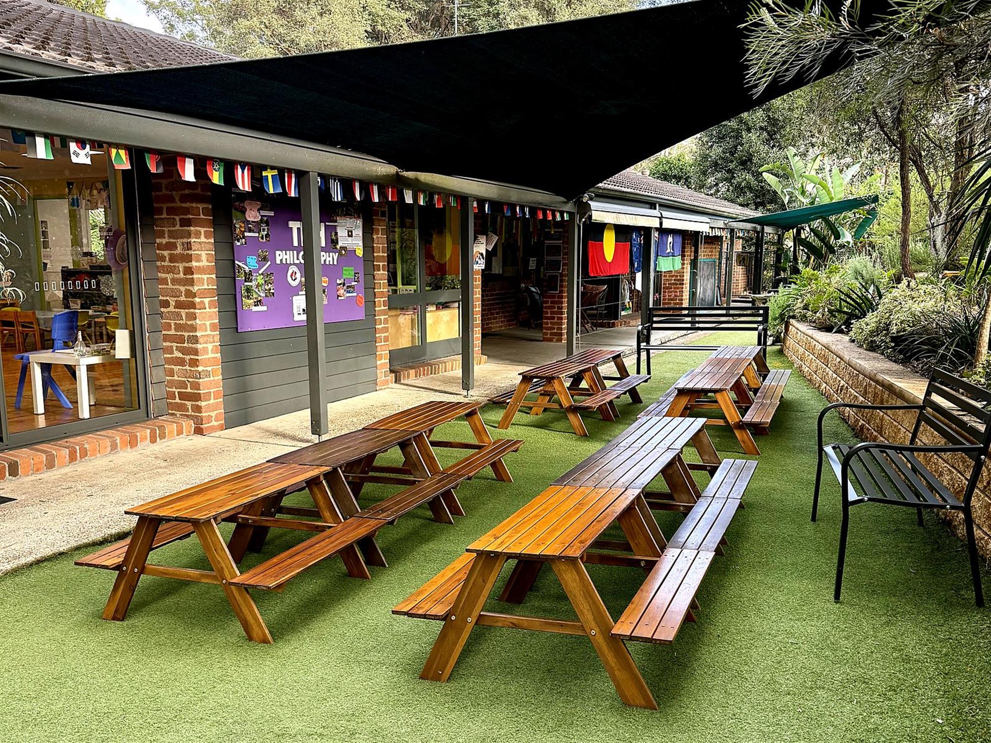 Bright Lady Bugs preschool classroom with timber floors and children's artwork on the walls